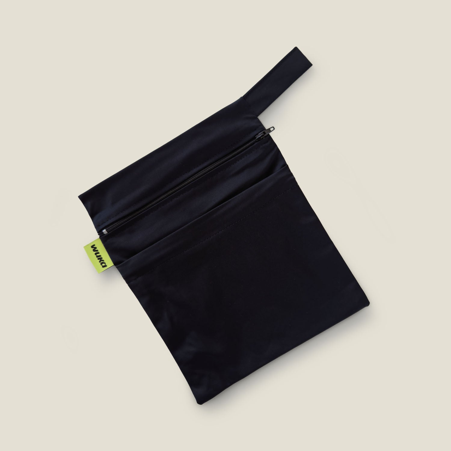 WUKA Two Pocket Changing Bag in black, laid flat with both zip compartments visible and red WUKA label on the side, designed for discreet and odour-protective storage.