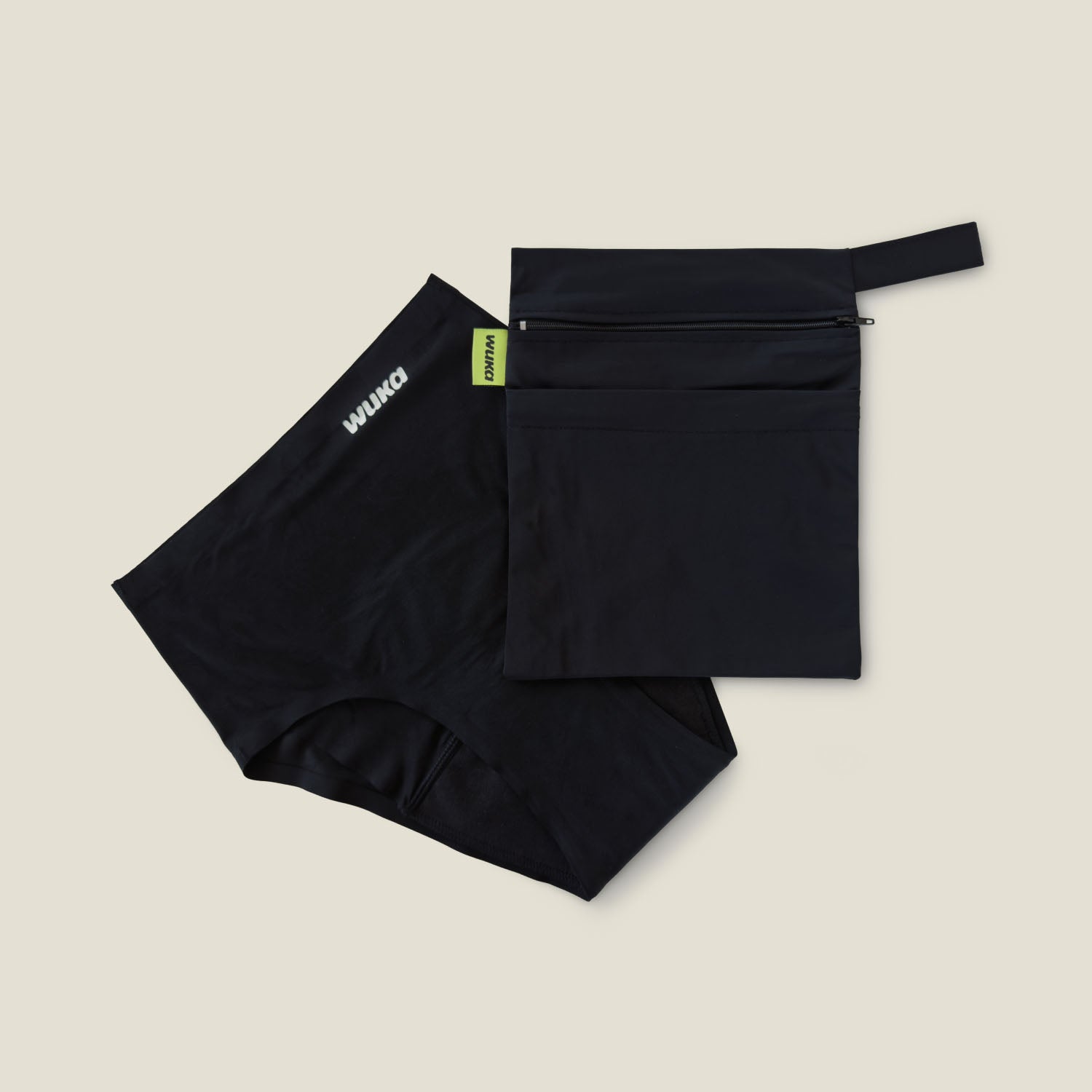 WUKA Two Pocket Changing Bag displayed alongside black seamless period pants, highlighting the practical pairing for hygienic and organised period management.