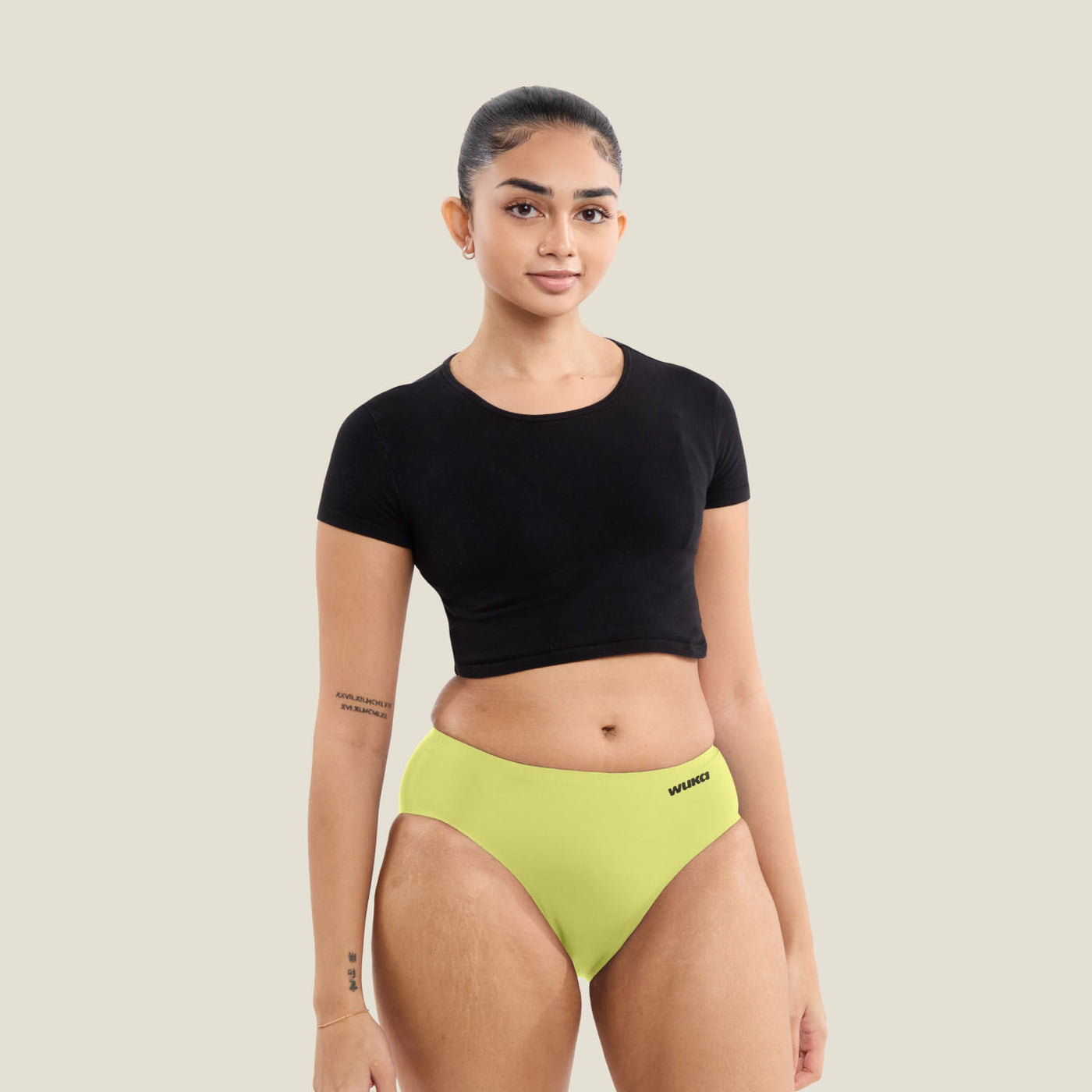 Teen wearing WUKA Stretch Seamless Midi Brief in limited edition Lime Punch, designed for heavy flow. Leak-proof period underwear with up to 12 hours of protection.