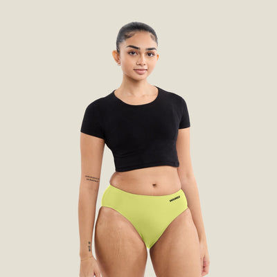 Teen wearing WUKA Stretch Seamless Midi Brief in limited edition Lime Punch, designed for heavy flow. Leak-proof period underwear with up to 12 hours of protection.