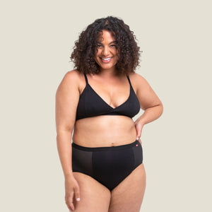 Confident woman wearing WUKA Ultimate™ High Waist Medium Flow Period Pants — sustainable, leak-proof protection with a flattering high-rise fit