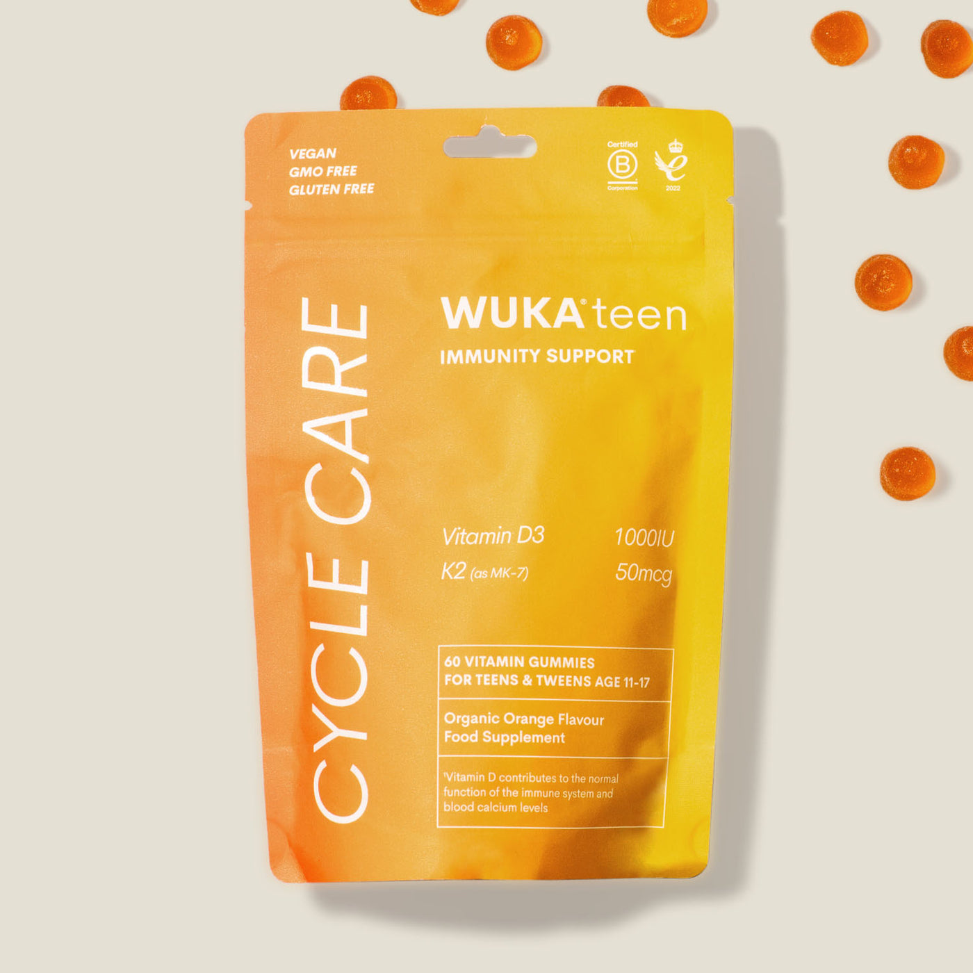WUKA teen immunity support gummies pouch with scattered orange gummies, highlighting ingredients like vitamin D3 and K2 for teens aged 11–17.