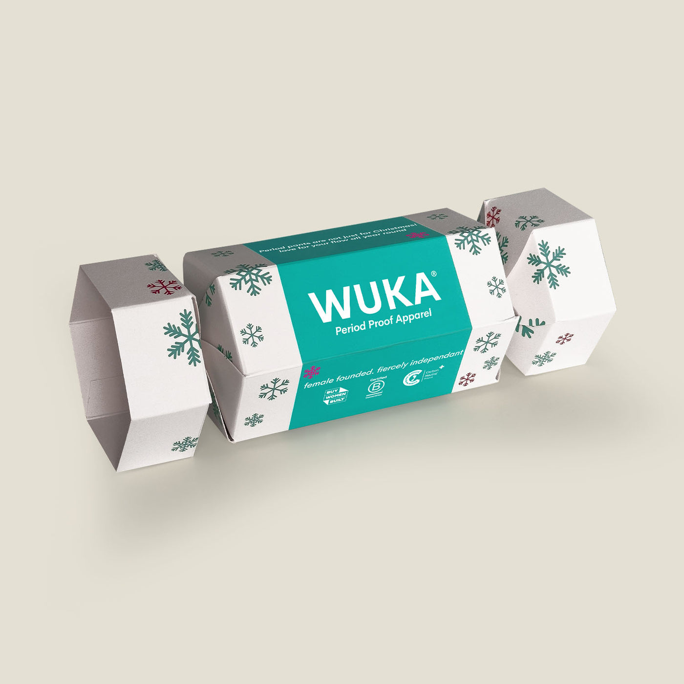 WUKA Cracker Gift Box in white with green and red snowflake prints – a festive, eco-friendly cracker packed with reusable period products.