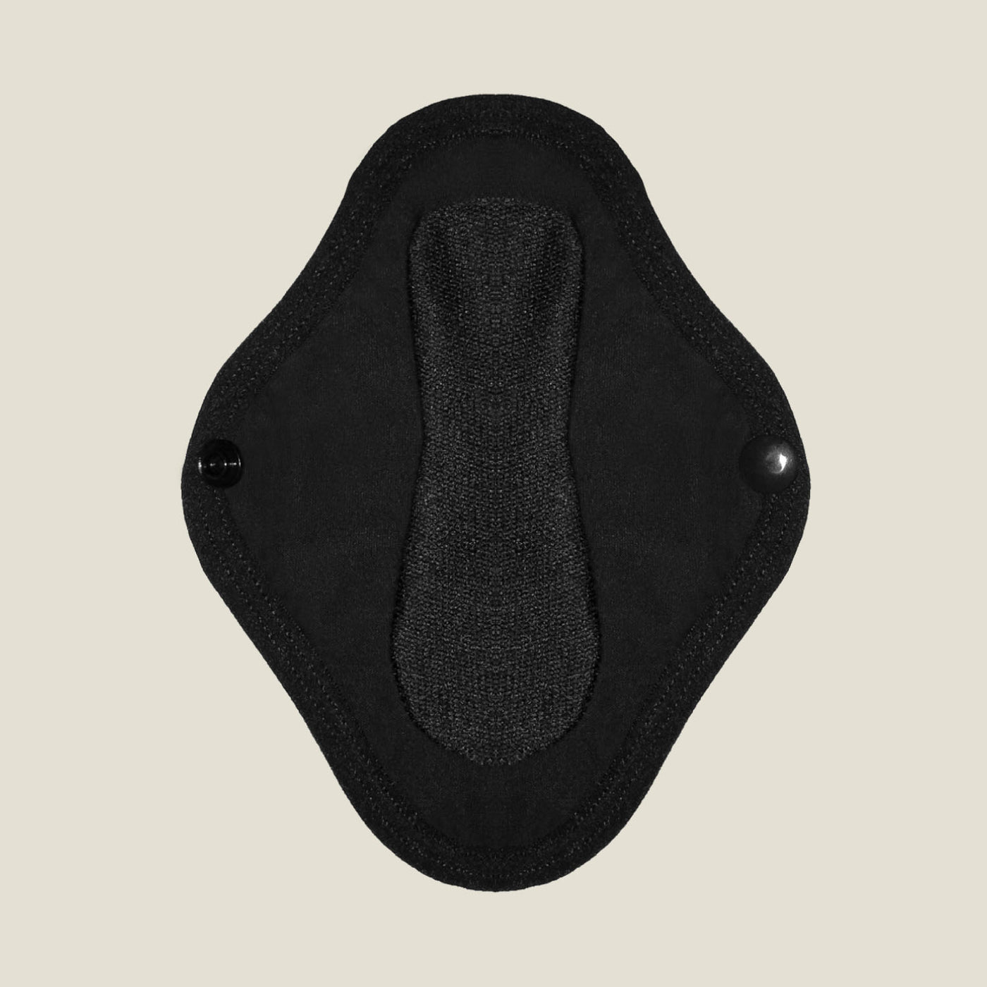 Close-up view of the absorbent inner layer of the WUKA reusable panty liner for light flow, featuring secure popper fastenings for a snug fit.
