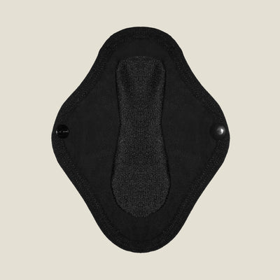 Close-up view of the absorbent inner layer of the WUKA reusable panty liner for light flow, featuring secure popper fastenings for a snug fit.