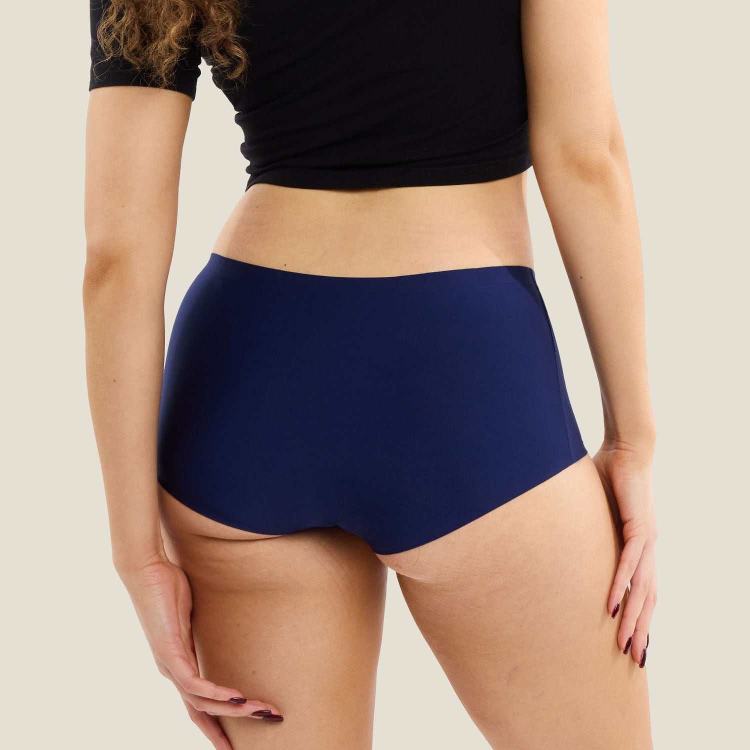 Rear view of WUKA Teen Stretch™ Boxer Short in navy, showcasing full coverage and smooth, leak-proof fit for teens during periods.