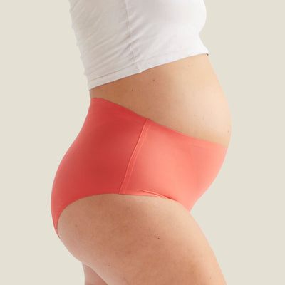 Side angle of WUKA Drytech™ High Waist Incontinence Brief in Coral Pink, demonstrating sleek fit and stretch for light leaks.