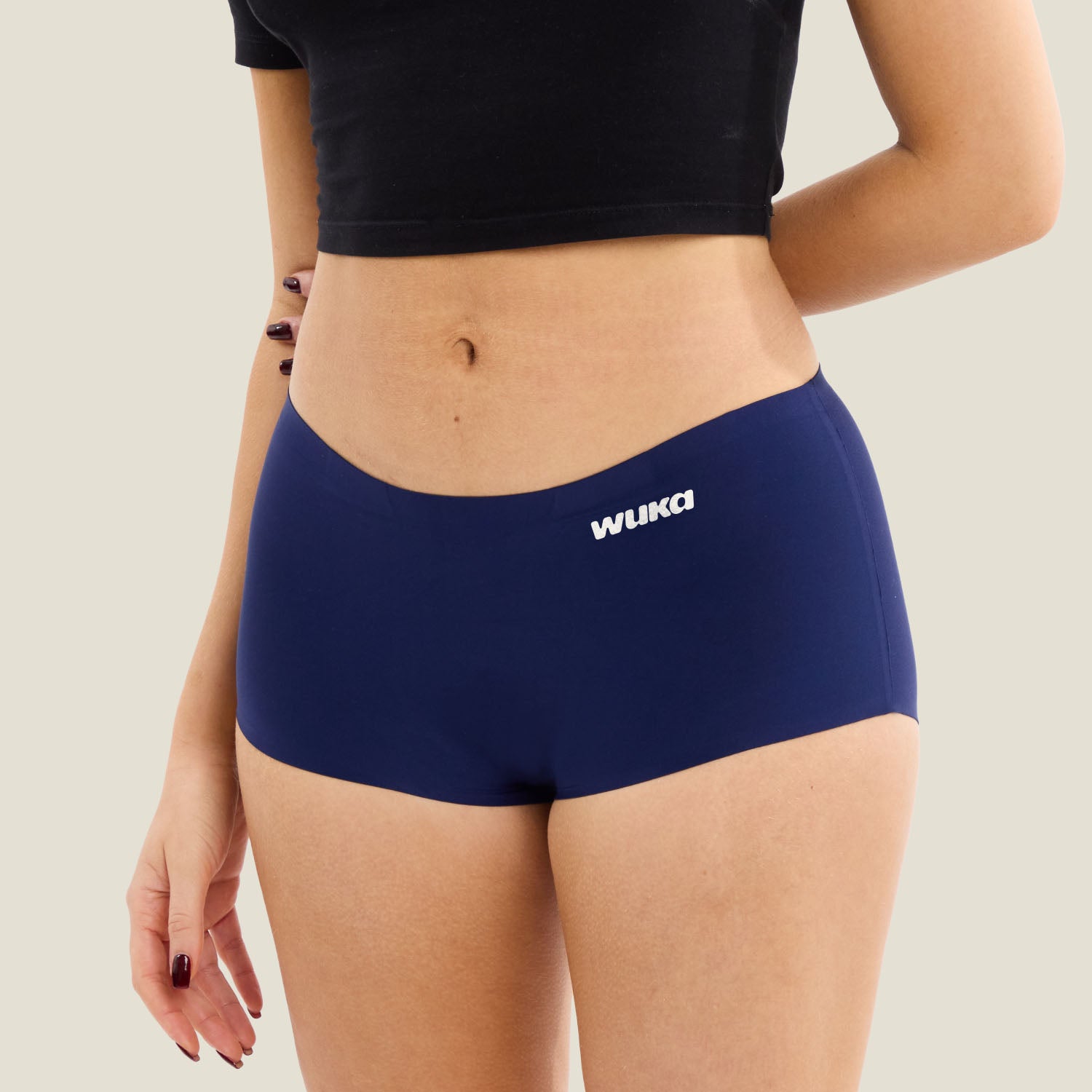 Side profile of model wearing WUKA Teen Stretch™ Boxer Short in navy, emphasising sleek design and soft, stretchy fit.