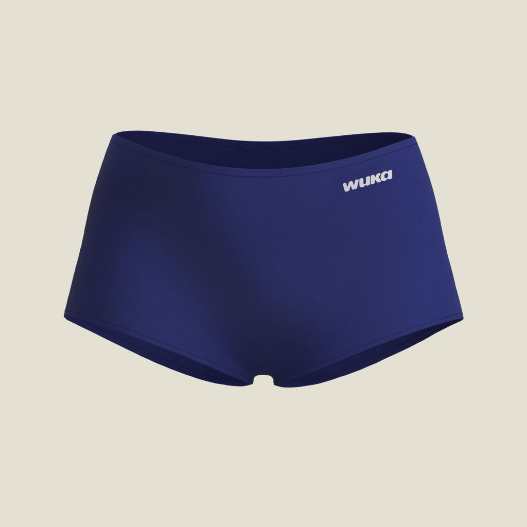 Flat lay of WUKA Teen Stretch™ Boxer Short in navy, designed for heavy flow with seamless construction and high absorbency core.