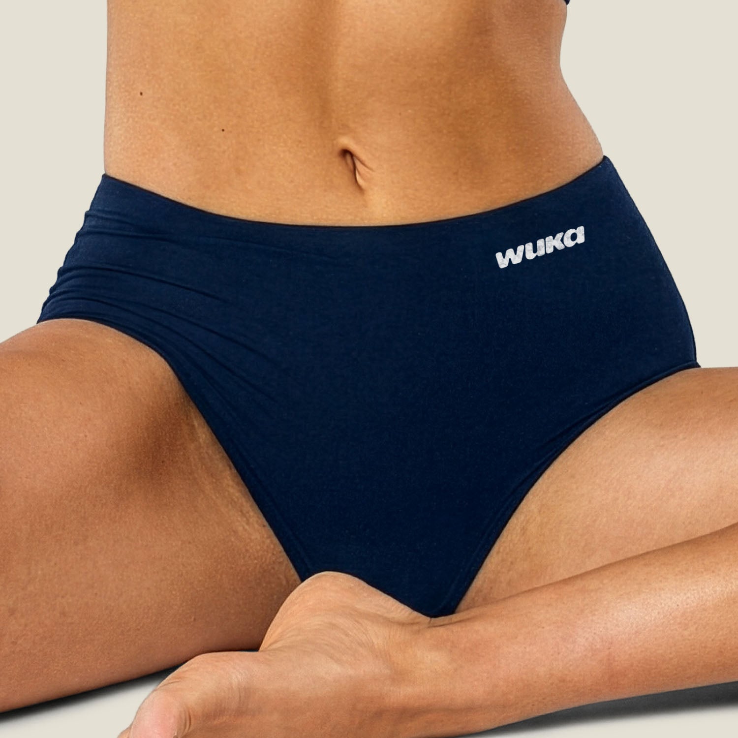 Close-up lifestyle image of WUKA Stretch™ Midi Brief in Navy for heavy flow, highlighting the ultra-soft, midi design that offers flexible fit, all-day comfort, and reliable leak-proof period protection. Sustainable, reusable alternative to disposable pads and tampons.