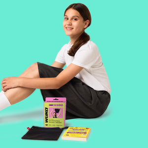 Smiling teen girl with WUKA Stretch black period-proof underwear, changing bag, and new brand packaging highlighting back to school offer on leak-proof, size-flexible teen period pants designed for growing bodies and everyday comfort.