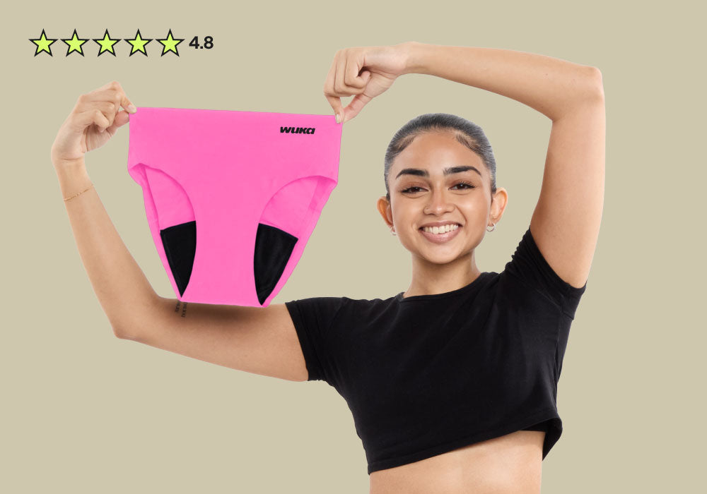Smiling teen holding up bright pink WUKA Teen Stretch™ Period Pants, showcasing new colour options. Multi-size reusable underwear designed for growing teens. Rated 4.8 stars.